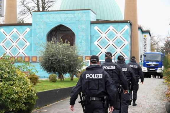 German police officers walk towards the Islamic Center Hamburg, during a raid, due to suspicion of members acting against a constitutional order and supporting the militant group Hezbollah in Hamburg, Germany, November 16, 2023.