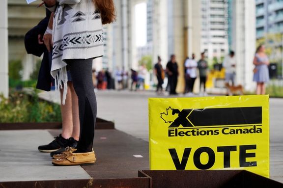 People line up outside a polling station to vote in Canada's federal election, in Toronto, Ontario, Canada September 20, 2021.