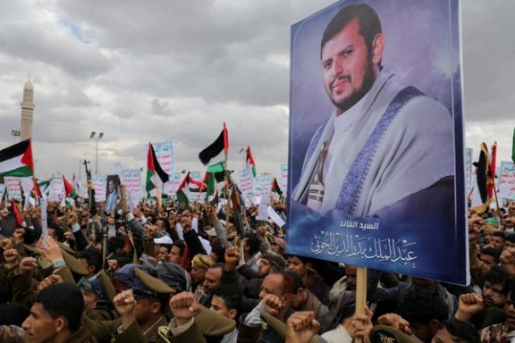 A demonstrator holds up a portrait of Houthi leader Abdul-Malik al-Houthi at a rally to show support for Palestinians in Gaza, in Sanaa, Yemen, February 9, 2024.