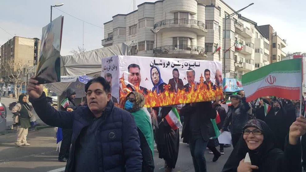 A poster showing opposition leaders burning, during a pro-government march in Tehran on Saturday