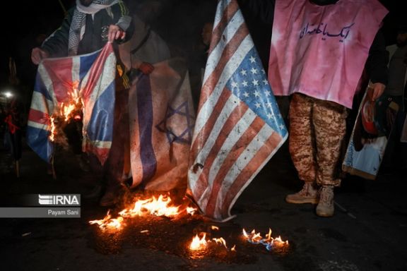Regime-sponsored demonstrators burn US, British and Israeli flags during a gathering in support of Yemen in front of the British embassy in Tehran on January 12, 2024.
