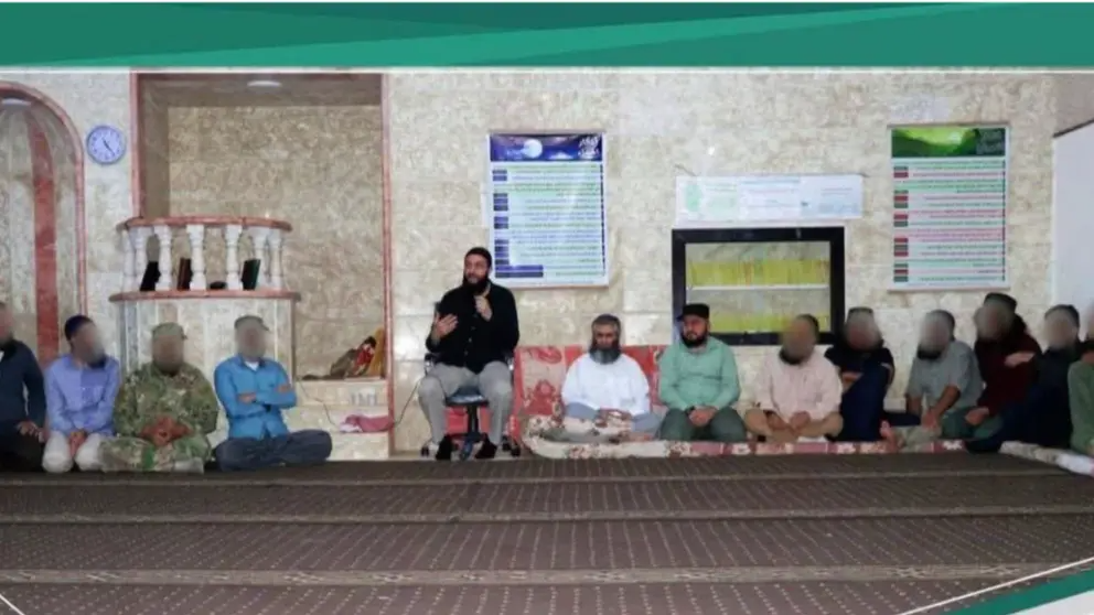 Abdolrahman Fattahi (in white shirt) in a meeting with Abu Mohammad al-Julani (on chair) in Idlib 