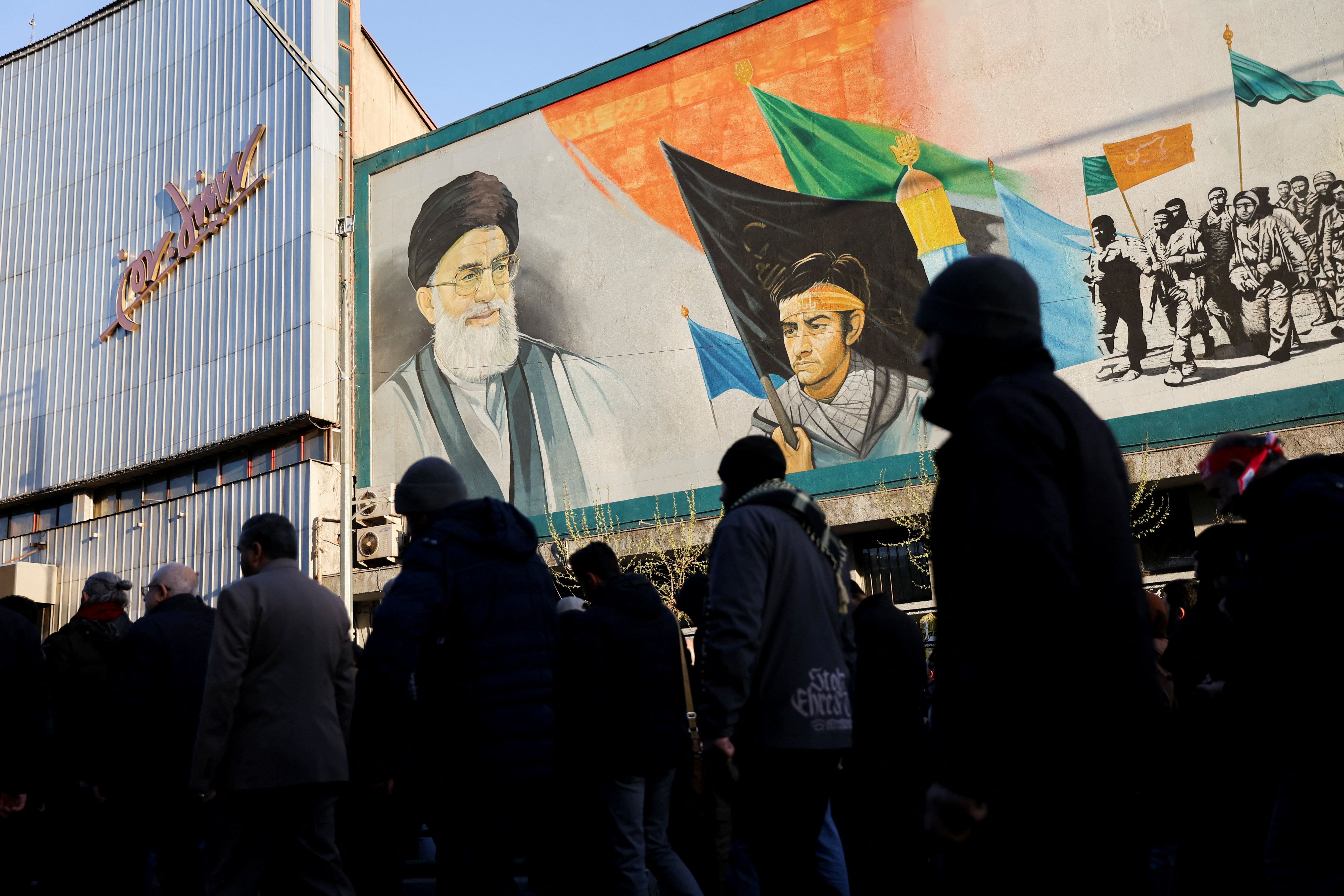 People walk near a mural featuring an image of Iran's Supreme Leader Ali Khamenei as people gather after Khamenei was killed in Israeli and US strikes on Saturday, in Tehran, Iran, March 1, 2026. 