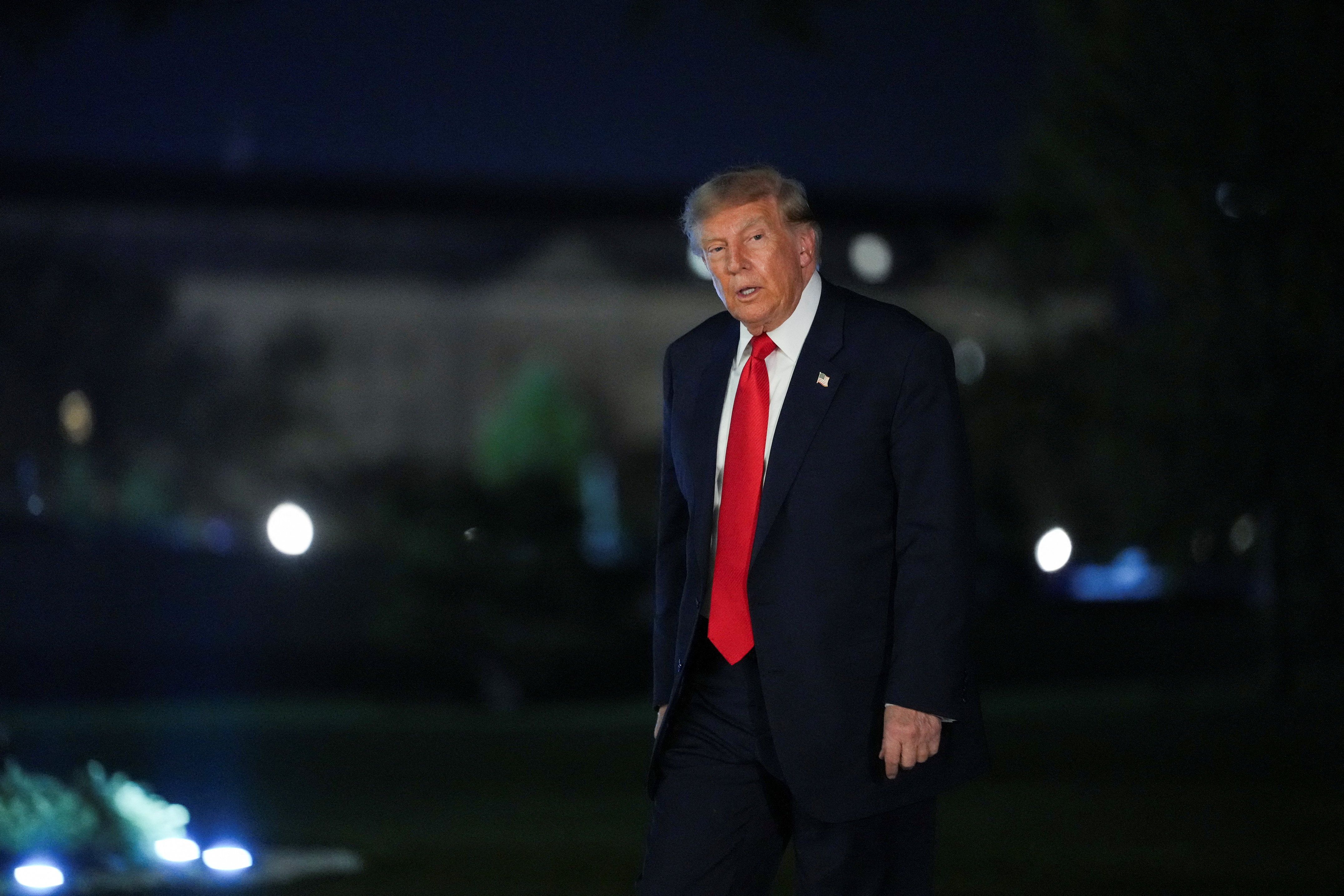 US President Donald Trump walks after disembarking from Marine One as he returns from a campaign rally in Syracuse, New York, on the South Lawn of the White House in Washington, DC, on October 9, 2026. 