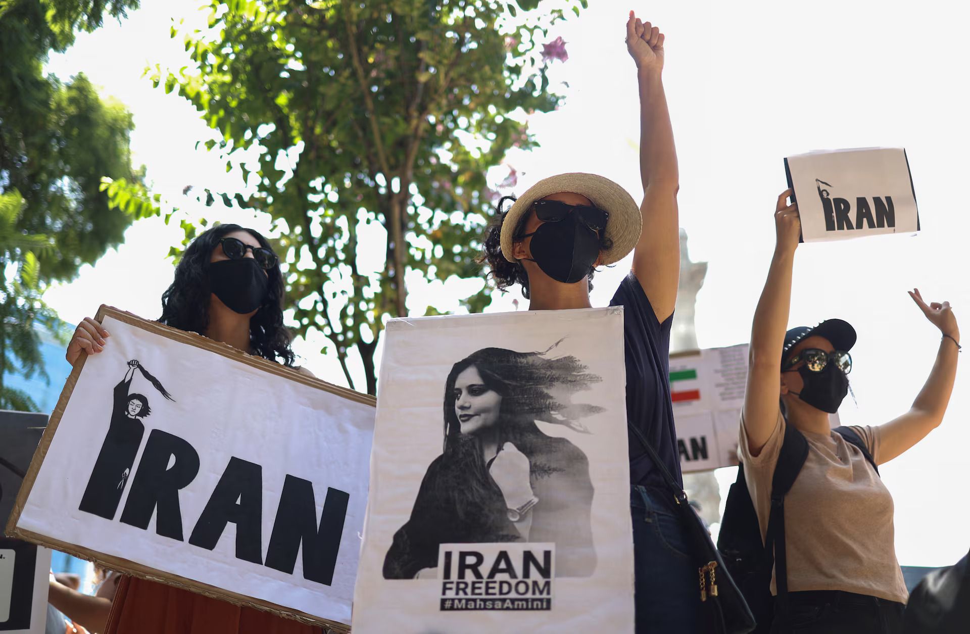 Women hold signs during a protest against the Islamic regime of Iran and following the death of Mahsa Amini, at the Angel of Independence monument in Mexico City, Mexico October 1, 2022.