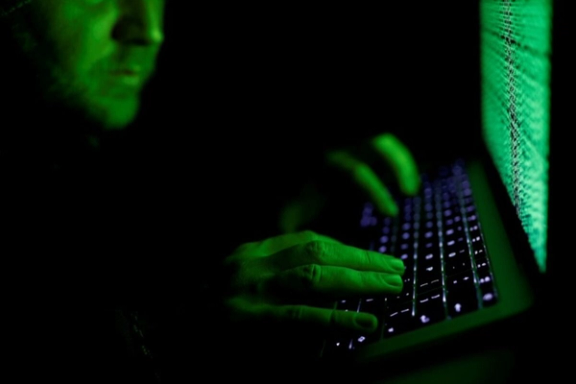 A man types on a computer keyboard in front of the displayed cyber code in this illustration picture taken on March 1, 2017.