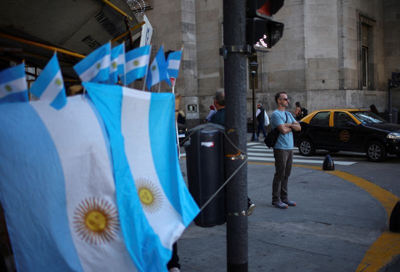 A man stands next to a street store selling Argentine flags, in downtown Buenos Aires, Argentina April 14, 2025.