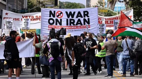 People hold placards and march in Los Angeles, USA.