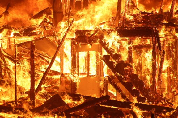 Flames engulf a structure as the Eaton Fire burns in Pasadena, January 7.