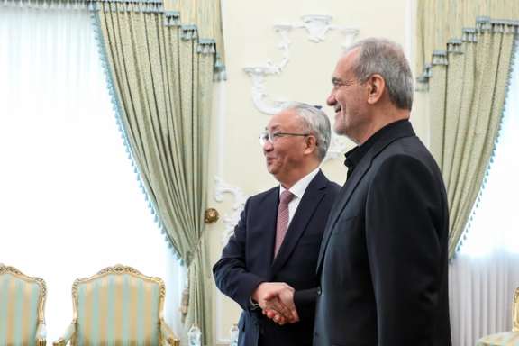 Iran's President Masoud Pezeshkian (right) meets China's vice premier, Zhang Guoqing, in Tehran on Dec. 4, 2024