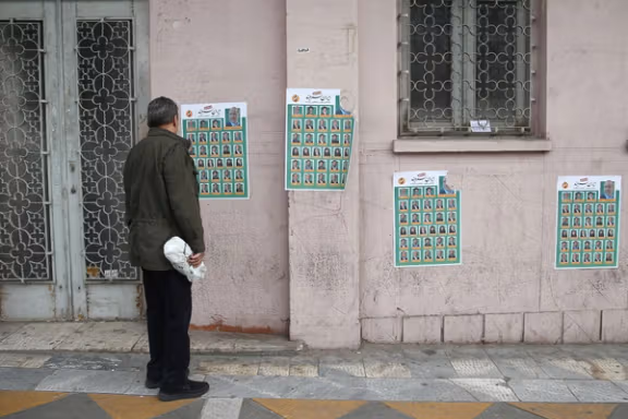 A man looks on parliamentary election campaign posters in Tehran, Iran February 19, 2020.