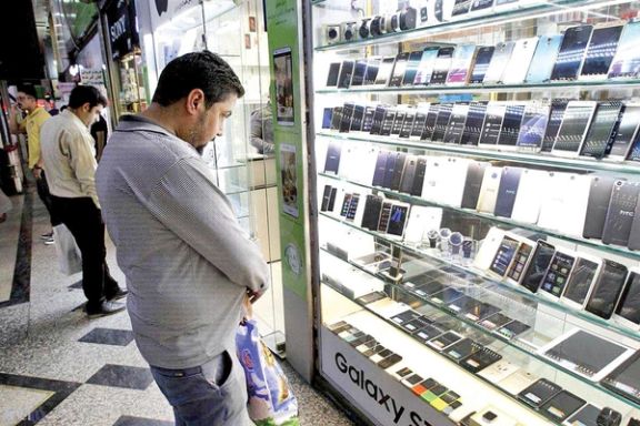 People looking at cellphone shops in Tehran