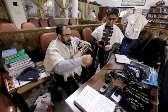 An Iranian rabbi getting ready for a religious ceremony
