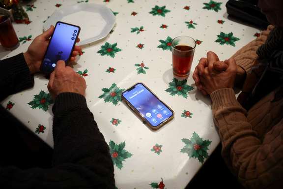 Said and Guiti, who have lived in Spain for over 40 years as refugees from Iran, try to call relatives in Iran from Barcelona, Spain January 13, 2026.