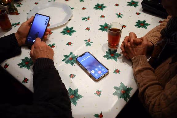 Said and Guiti, who have lived in Spain for over 40 years as refugees from Iran, try to call relatives in Iran from Barcelona, Spain January 13, 2026.