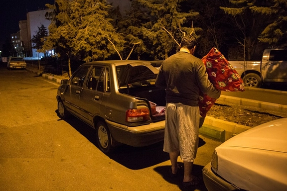 An internet taxi driver preparing to sleep in his car (Undated)