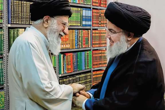 Slain Hezbollah Leader Hassan Nasrallah embraces Iran Supreme Leader Ali Khamenei in an undated handout photo.