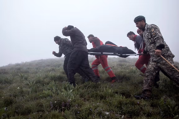 Rescuers at the remote region where Raisi's helicopter crashed in May 2024