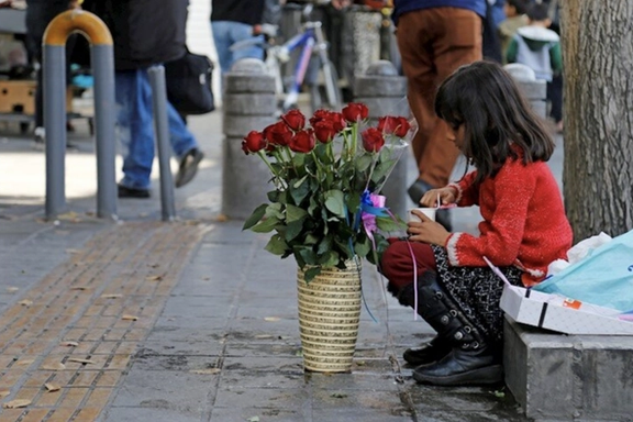 An Iranian girl selling flowers on streets of Tehran