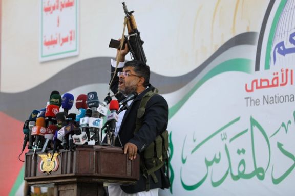 Mohammed Ali al-Houthi, a member of the Houthi supreme political council, speaks while holding a gun, as supporters of the Houthi movement rally to denounce air strikes launched by the US and Britain on Houthi targets, in Sanaa, Yemen January 12, 2024.