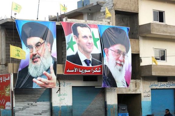 Banners of Iran's Supreme Leader Ali Khamenei and Hezbollah chief Hassan Nasrallah besides Syrian President Bashar al-Assad in Syria