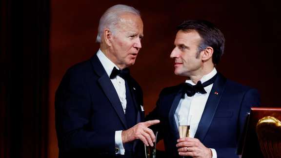 US President Joe Biden and France's President Emmanuel Macron making a toast, as the Bidens host the Macrons for a State Dinner at the White House, in Washington, December 1, 2022