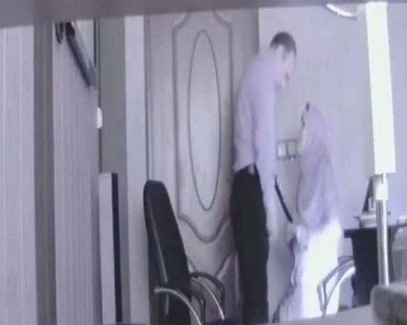 Screen grab from a video showing an Iranian official engaging in sex with a married woman at his office.