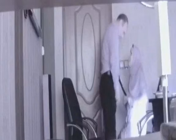 Screen grab from a video showing an Iranian official engaging in sex with a married woman at his office.