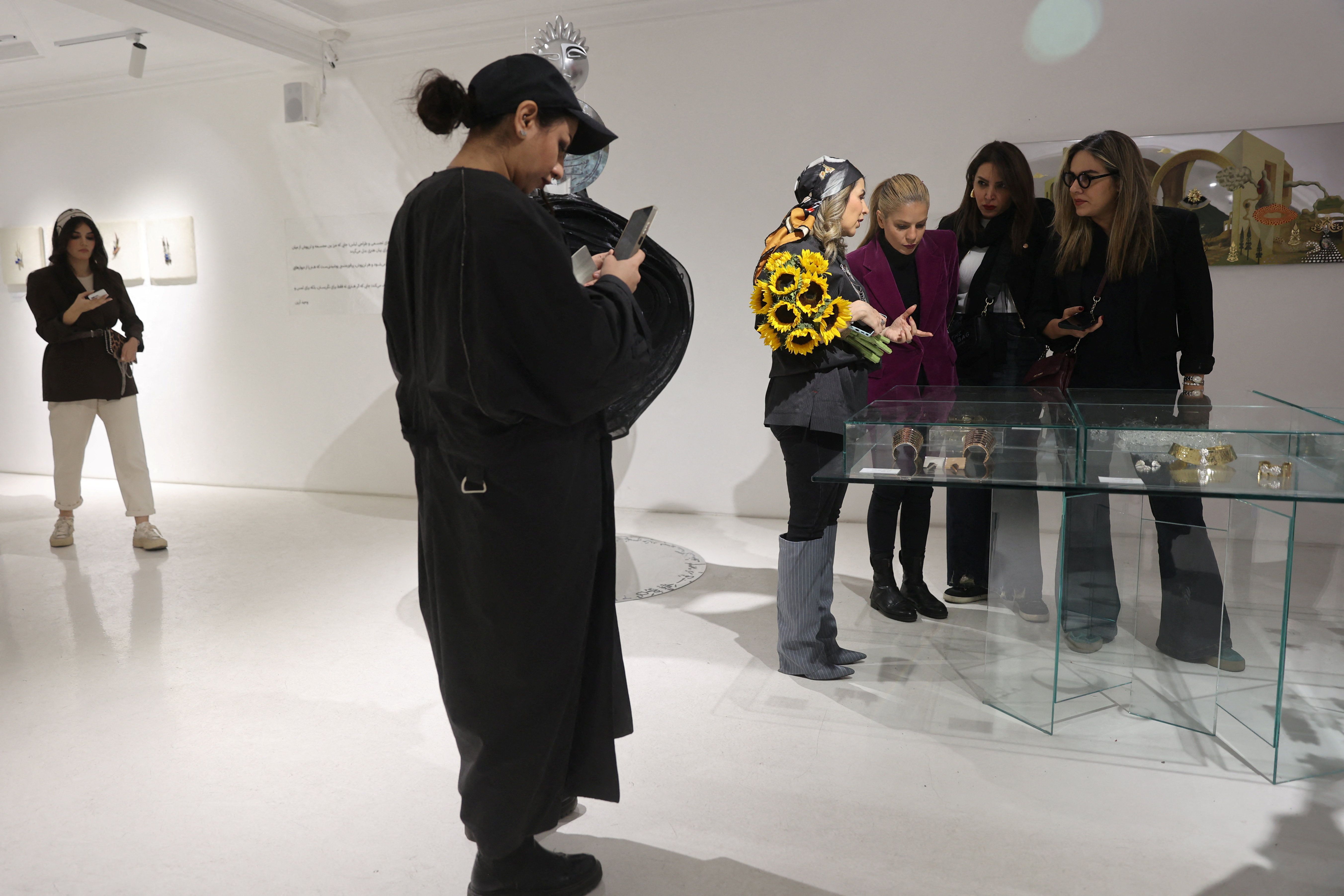 Iranian women visit the Tehran Design Week event in a gallery in Tehran, Iran, November 16, 2025.