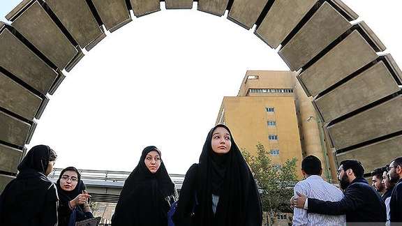 Female students at the gate of a university in Iran