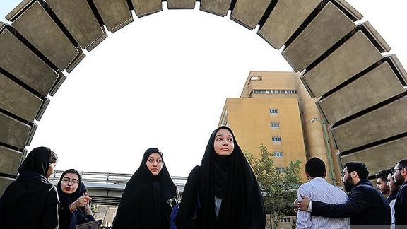 Female students at the gate of a university in Iran