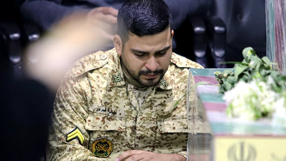 A soldier from Fatemiyoun brigade mourns at the funeral of a comrade killed in Syria, January 8, 2024