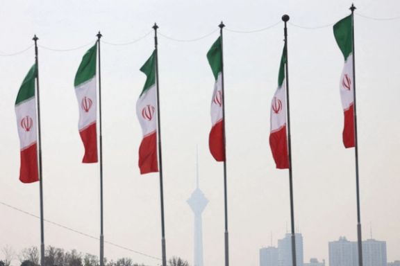 Six flags of the Islamic Republic of Iran with Tehran's Milad Tower in the background
