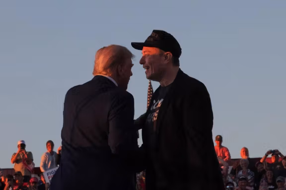 Tesla CEO and X owner Elon Musk stands with Republican presidential nominee former US president Donald Trump during a campaign rally, on the day Trump returns to the site of the July assassination attempt against him, in Butler, Pennsylvania, U.S., October 5, 2024.