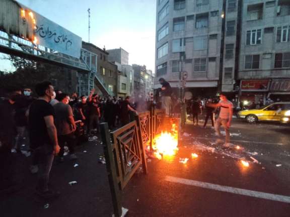 People light a fire during a protest over the death of Mahsa Amini, a woman who died after being arrested by the Islamic republic's "morality police", in Tehran, Iran September 21, 2022.
