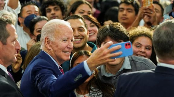 President Joe Biden takes a selfie with supporters as he participates in a campaign fundraising event for Rep. Mike Levin (D-CA) in San Diego, November 3, 2022