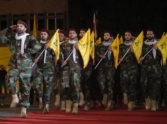 Members of Hezbollah march with party's flags during a rally in Beirut.