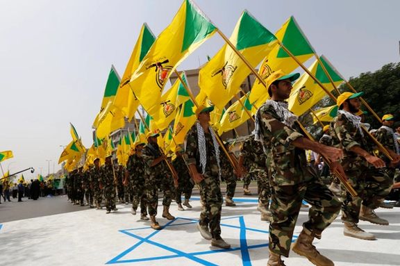 Iran-backed Kata’ib Hezbollah members parade during a parade in Baghdad, Iraq