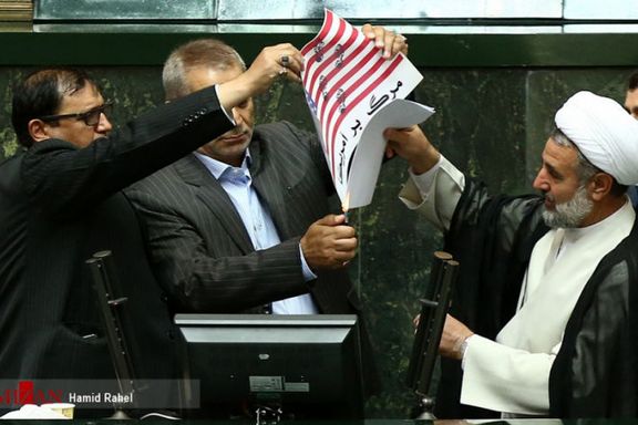 A group of Iranian lawmakers burning a copy of the JCPOA