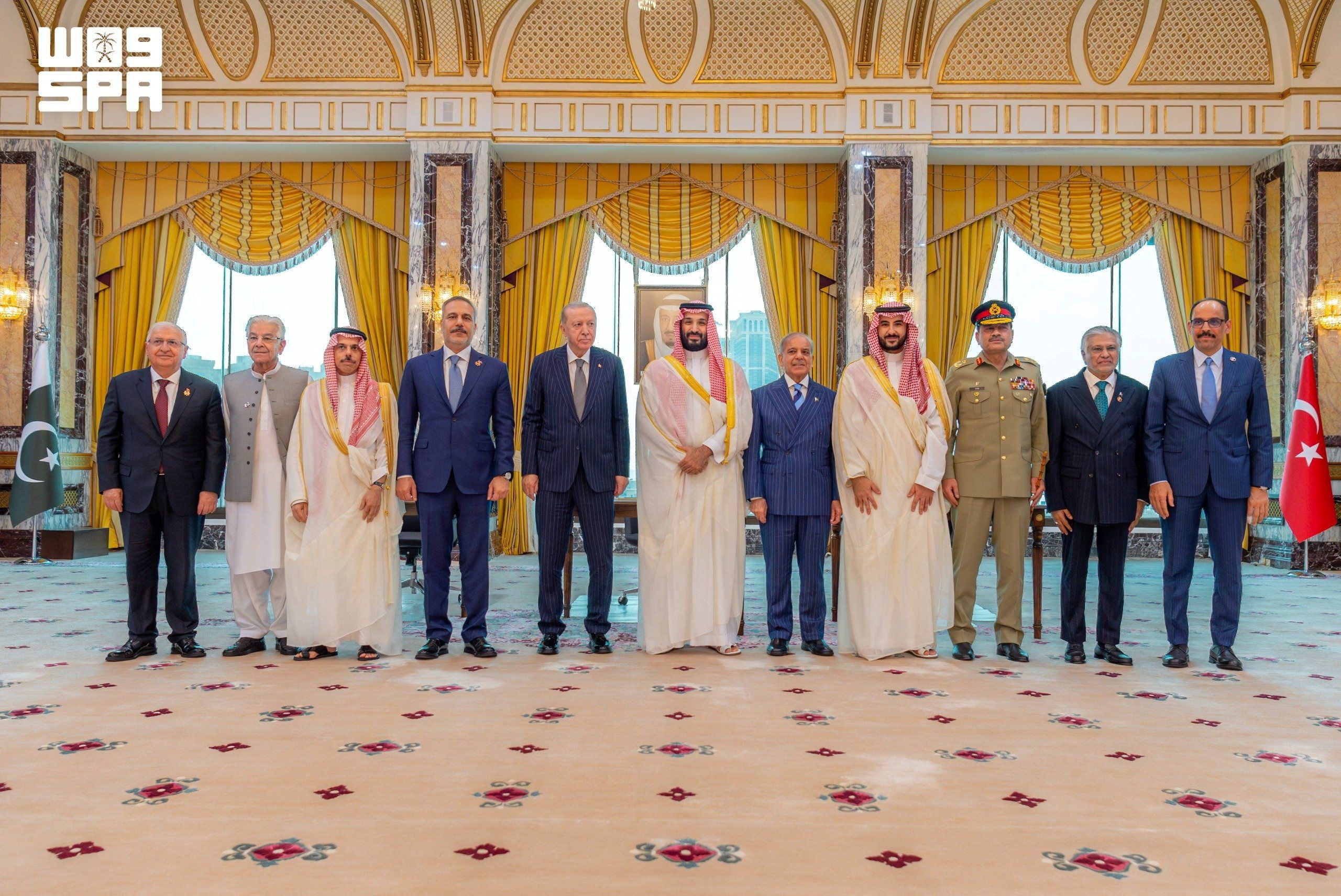 Turkish President Tayyip Erdogan, Saudi Crown Prince Mohammed bin Salman, and Pakistan's Prime Minister Shehbaz Sharif, accompanied by their ministers of Foreign Affairs and Defence, pose after signing a joint defence agreement in Mecca, Saudi Arabia, August 7, 2026. 