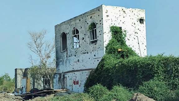 A view of a building damaged by clashes is seen on the outskirts of the Red Sea port city of Hodeidah, Yemen November 13, 2021