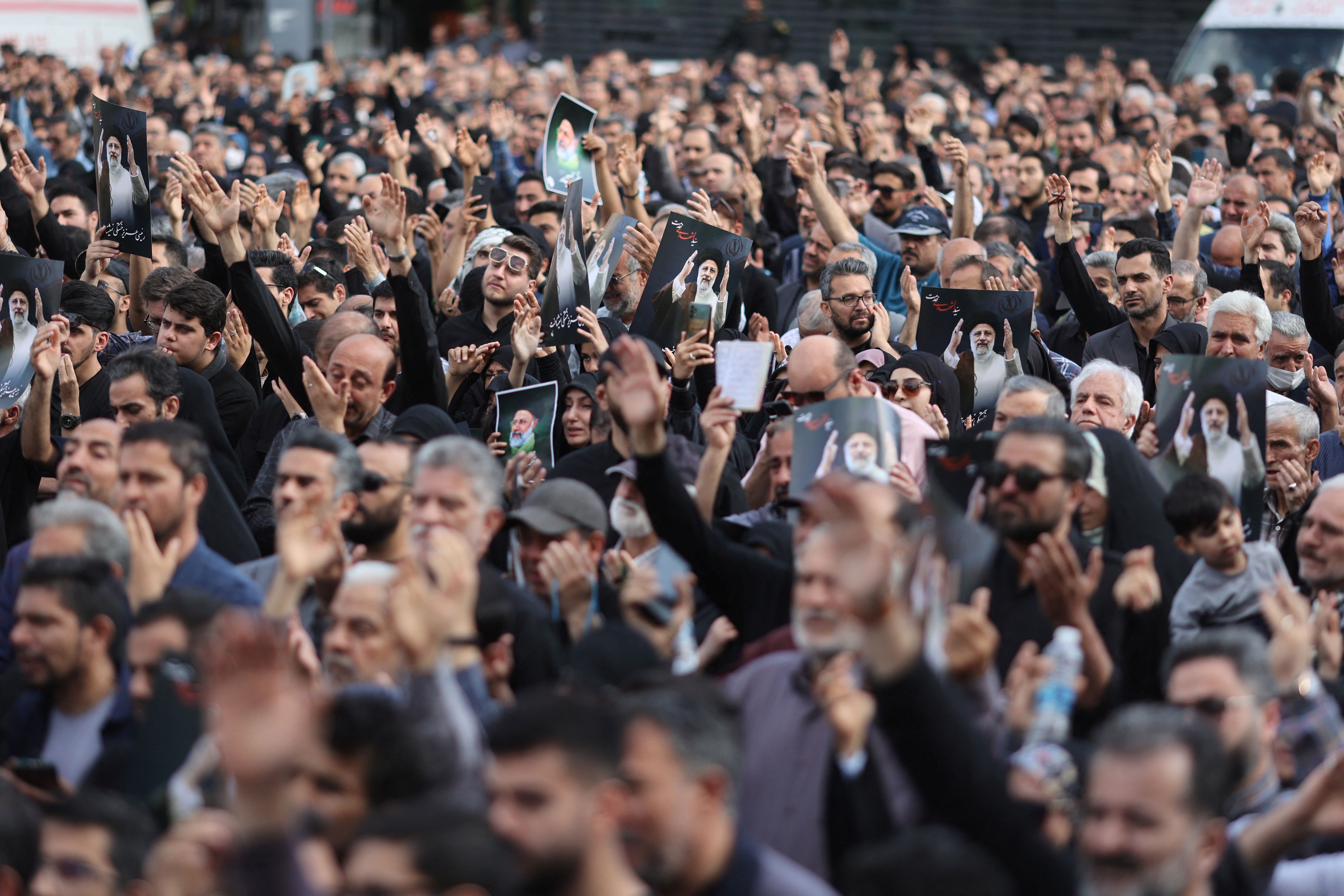 People gather to mourn for the death of the late Iran's President Ebrahim Raisi, in Tehran, Iran May 20, 2024. 