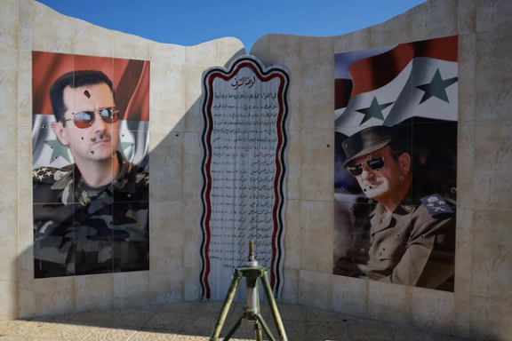 Images of Syria's Bashar al-Assad and former Syrian President Hafez al-Assad are damaged by bullet holes, as fighters of the ruling Syrian body inspect the damage at a military site, in the aftermath of an Israeli strike according to Syrian Observatory for Human Rights, after fighters of the ruling Syrian body ousted Syria's Bashar al-Assad, in Damascus, Syria, December 14, 2024.