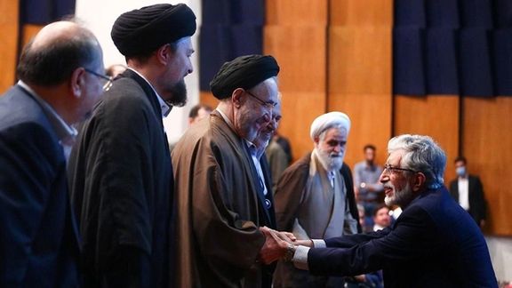 Gholam-Ali Haddad-Adel (R) shaking hands with former president Mohammad Khatami. May 30, 2023