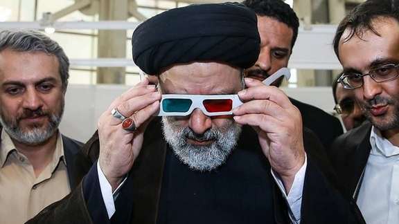 Iran's president Ebrahim Raisi with aides during a visit to a company