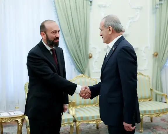 Iran's President Masoud Pezeshkian shakes hands with Armenia's foreign minister in Tehran on Oct. 5