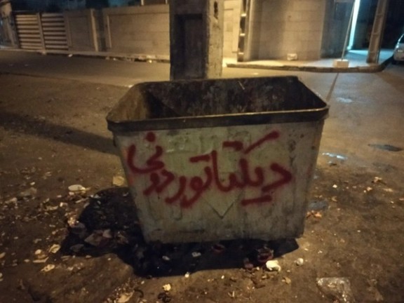 Protesters have written "Dictator disposal" on a garbage bin in Tehran. October 2022