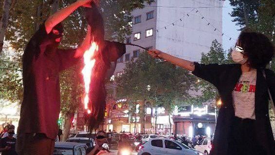 Women burning their hijab headscarves during anti-government protests