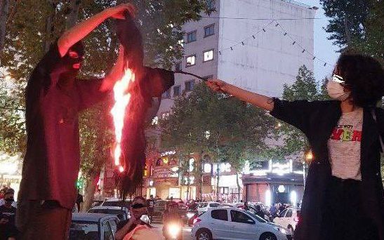 A woman burning her hijab headscarf in Lahijan, a provincial town, September 2022