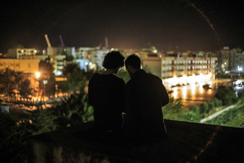 A file photo shows two men together in Iran. Health officials say sexual transmission has become the leading recorded route for new HIV cases.